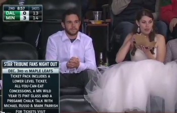 Relationship Goals: Woman wears wedding dress at hockey game